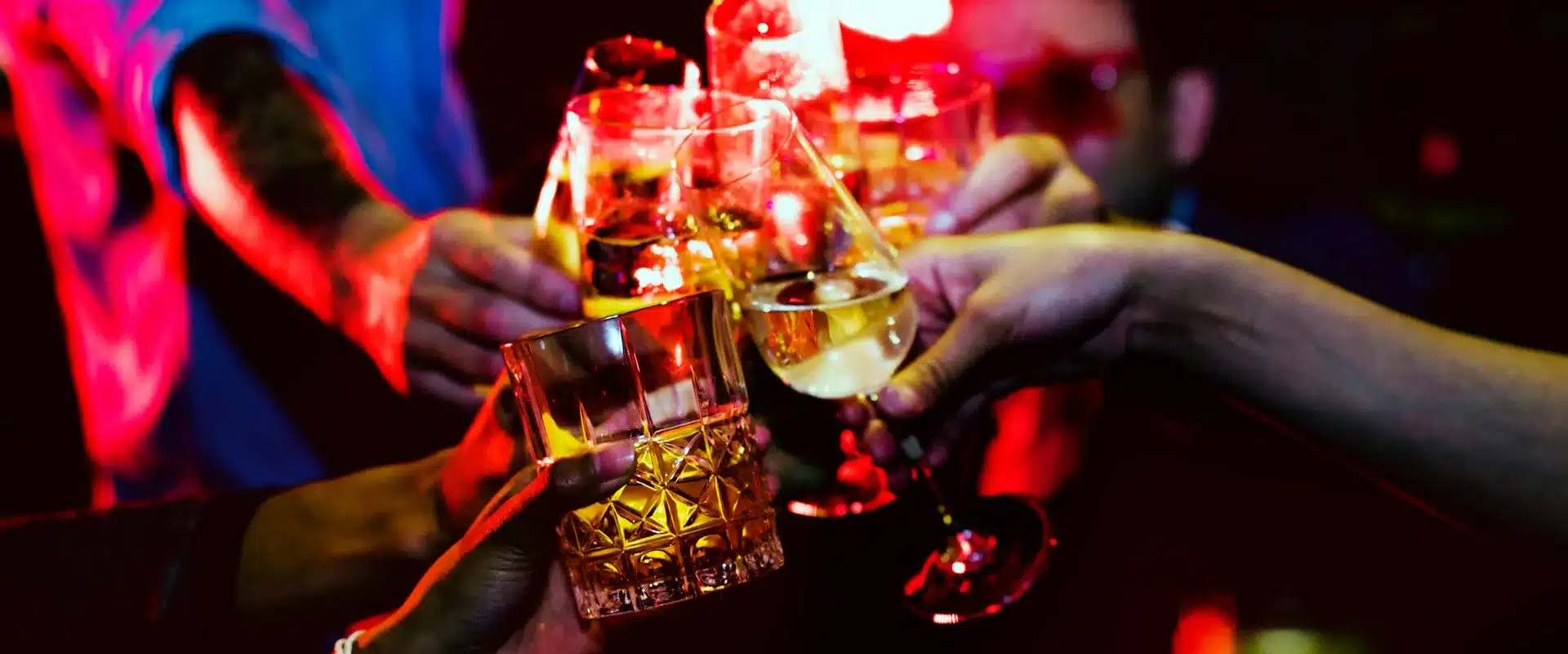 Drinks raised in nightclub lighting for a Barcelona stag nightlife guide