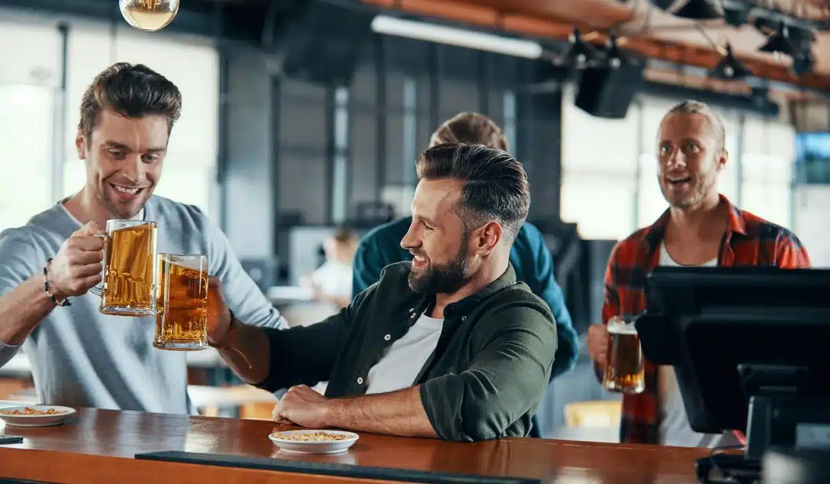 Group of men drinking beer at a bar during a Barcelona stag night