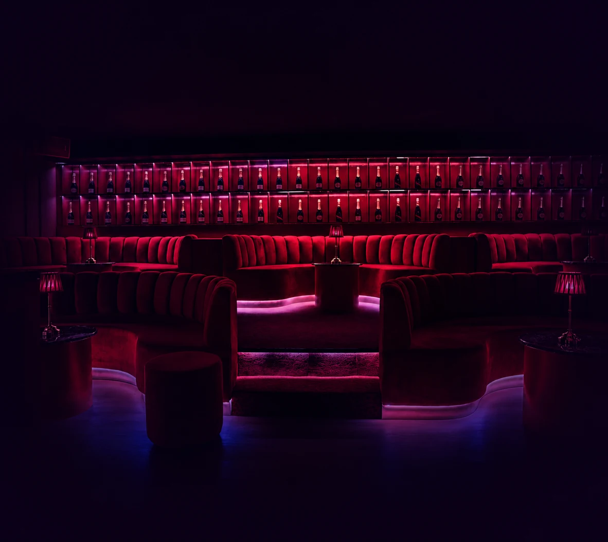 Play Beach Strip Club Barcelona lounge with red neon lighting and premium nightlife atmosphere